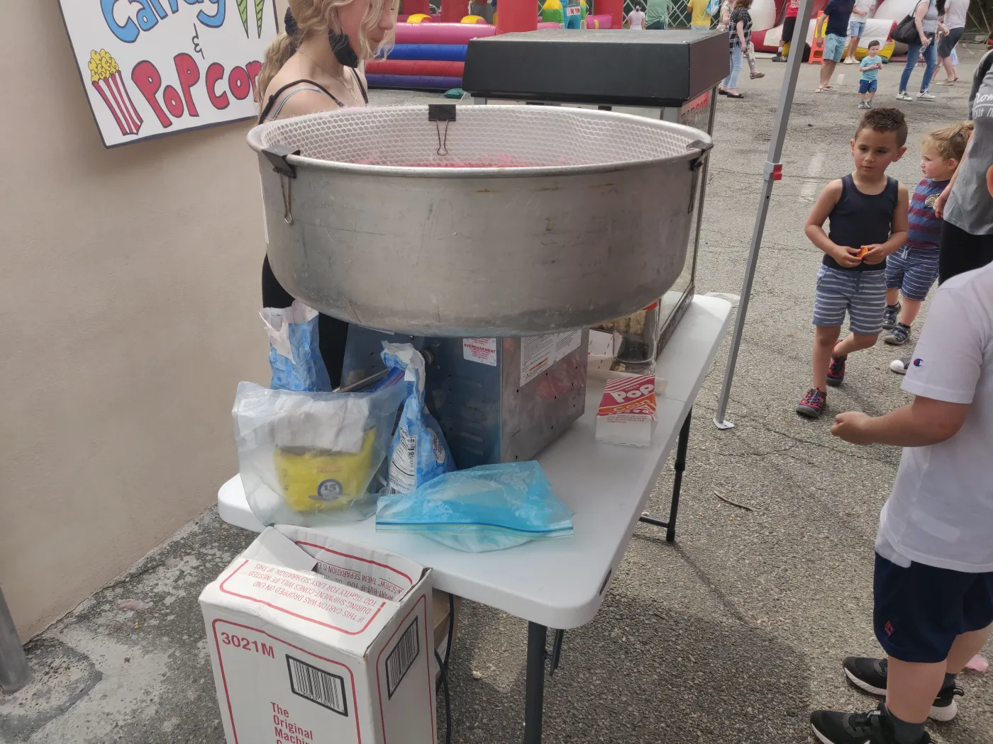 A cotton candy machine set up at an outdoor event